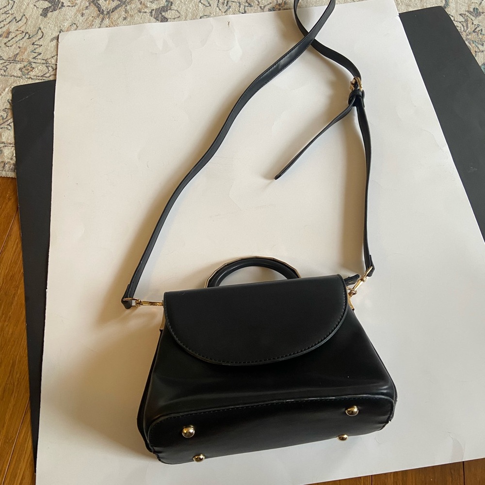Structured Black Top-Handle Satchel with Removable Strap. Gold hardware.